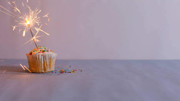 istock Delicious muffin and burning sparkler decorating 1407974759