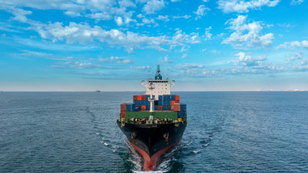 istock Aerial side view of cargo ship carrying container and running for export  goods  from  cargo yard port to custom ocean concept technology transportation , customs clearance. 1407975788