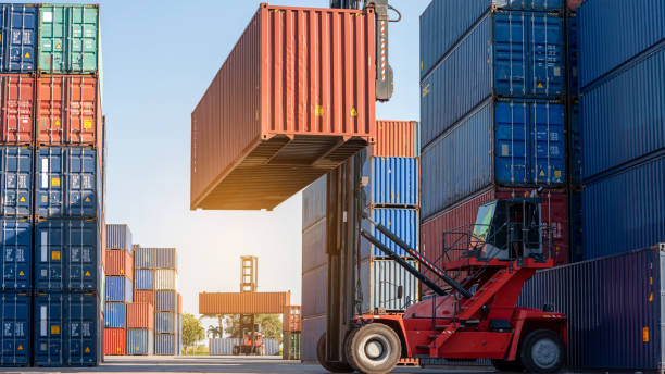 istock forklift working in the container cargo yard port loading cargo tank  logistic service and transportation concept. 1407975821