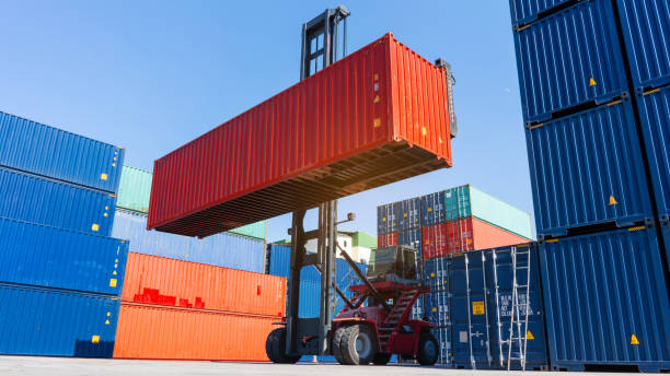 istock forklift working in the container cargo yard port loading cargo tank  logistic service and transportation concept. 1407975823