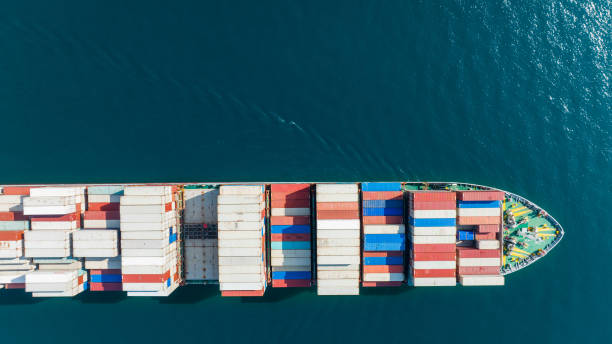 istock Aerial top view of cargo ship carrying container and running for export  goods  from  cargo yard port to custom ocean concept technology transportation , customs clearance. 1407975844