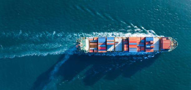 istock Aerial top view of cargo ship carrying container and running for export  goods  from  cargo yard port to custom ocean concept technology transportation , customs clearance. 1407975867