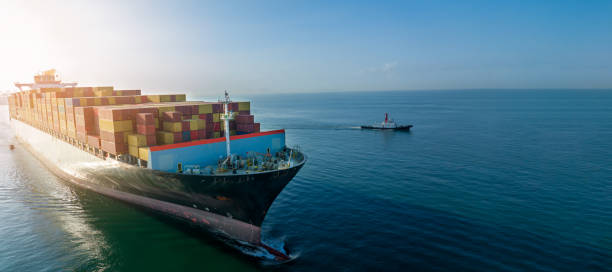 istock Aerial side view of cargo ship carrying container and running for export  goods  from  cargo yard port to custom ocean concept technology transportation , customs clearance. 1407975904