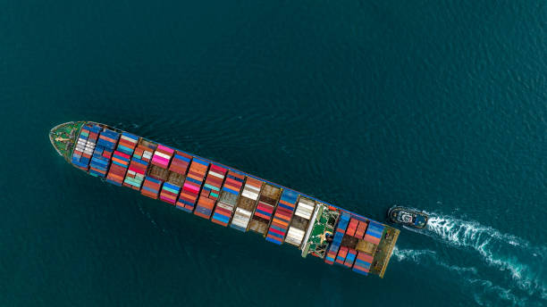 istock Aerial top view of cargo ship carrying container and running for export  goods  from  cargo yard port to custom ocean concept technology transportation , customs clearance. 1407975939