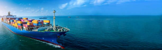 Aerial side view of cargo ship carrying container and running for export  goods  from  cargo yard port to custom ocean concept technology transportation , customs clearance.