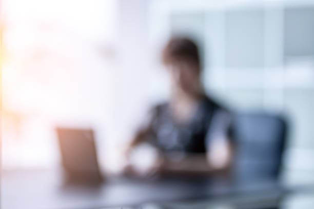 istock Girl working on laptop computer in an office.Bokeh effect 1407977295