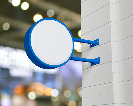 Hanging blue rounded signboard mockup over blur light and shadow of shopping mall, Light box signage, 3D rendering