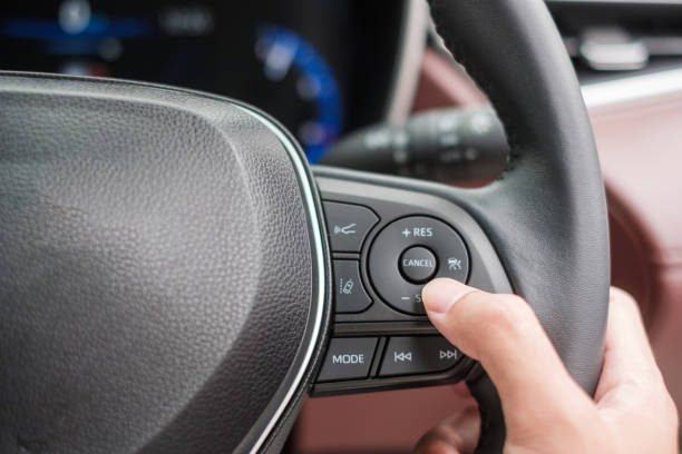 istock controlling steering wheel in electric modern automobile. Technology, Journey, trip and safety Transportation concepts 1407978247
