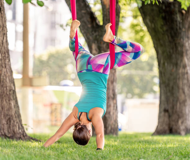 istock Girl doing fly yoga 1407978448
