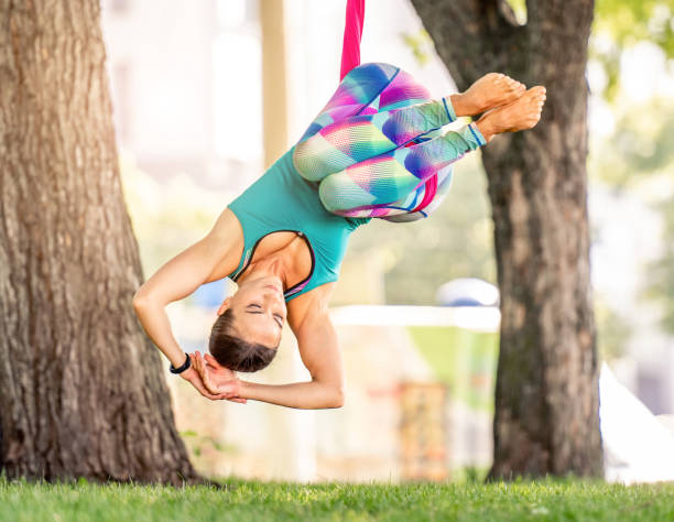 istock Girl doing fly yoga 1407978460