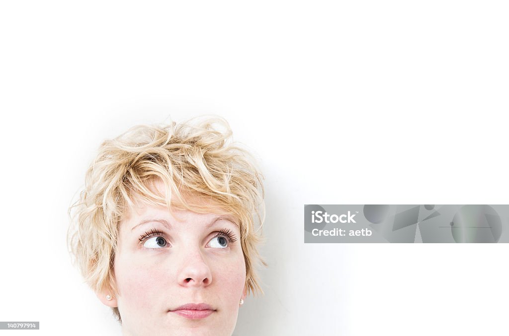 Blond Girl Looking up / Right Funny morning look of a young adult girl on a white background. 20-29 Years Stock Photo