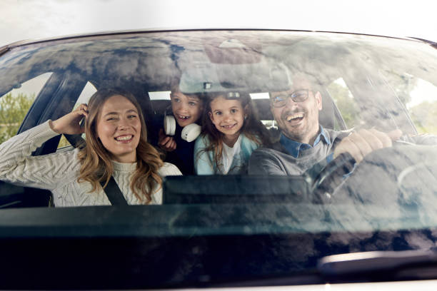 istock Happy family enjoying while going on a vacation by car. 1407979761