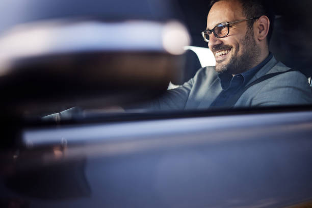 istock Happy businessman going on a trip by car. 1407979915