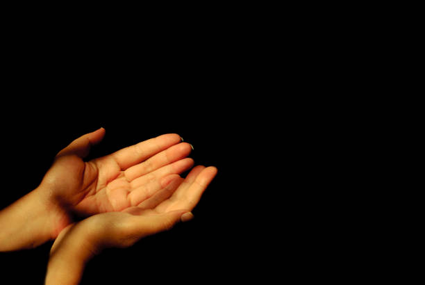 istock empty hands on black background with lights,wishes,freedom,liberty,peace,liberty concept 1407980195