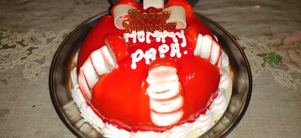 Anniversary celebration of mummy, papa or mom and dad . Anniversary strawberry cake.