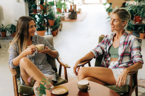 istock Two young attractive women have fun chatting and drinking coffee while sitting in a cafe. 1407982768