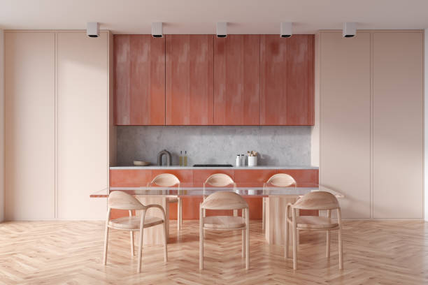 istock Stylish kitchen interior with eating table and seats on wooden floor 1407983585