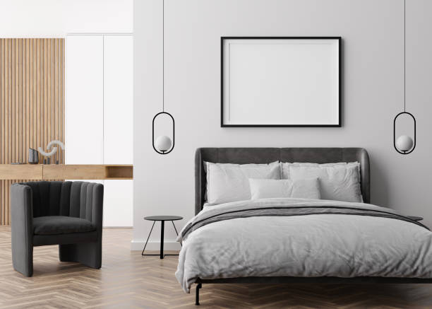 istock Empty picture frame on white wall in modern bedroom. Mock up interior in contemporary style. Free, copy space for your picture, poster. Bed, lamps. 3D rendering. 1407984310