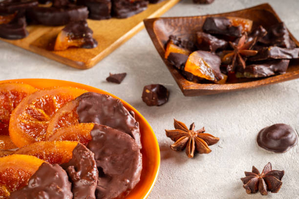 istock Candied oranges with chocolate. Dryed oranges and cinnamon 1407985111