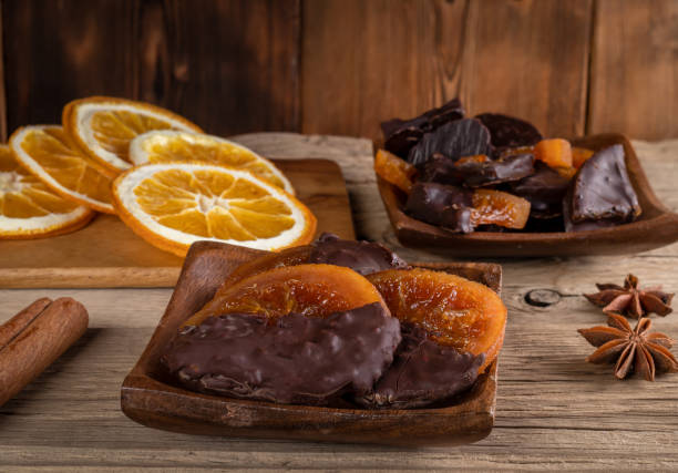 istock Candied oranges with chocolate. Dryed oranges and cinnamon 1407985149