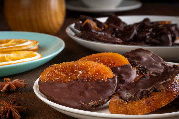 istock Candied oranges with chocolate. Dryed oranges and cinnamon 1407985190