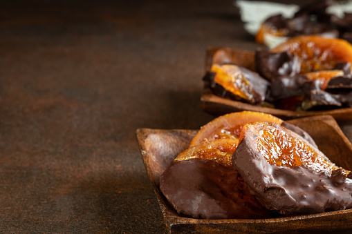 Candied oranges with chocolate. Dryed oranges and cinnamon. With copyspace.