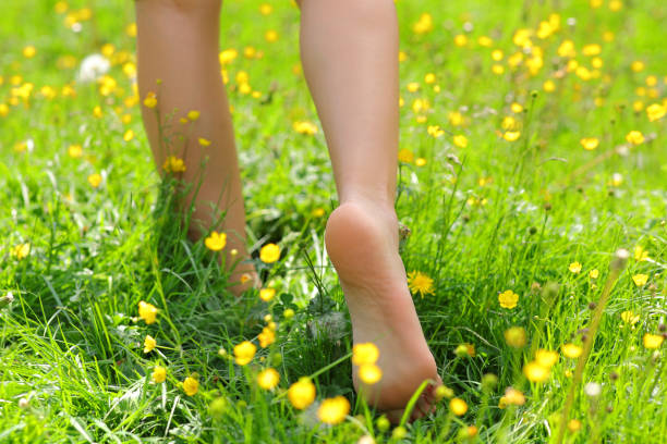 istock Woman feet walking on the grass 1407985815