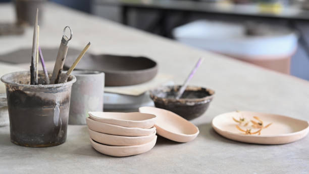 istock Set of handmade ceramic crockery on table in creative studio or potter store. 1407987685