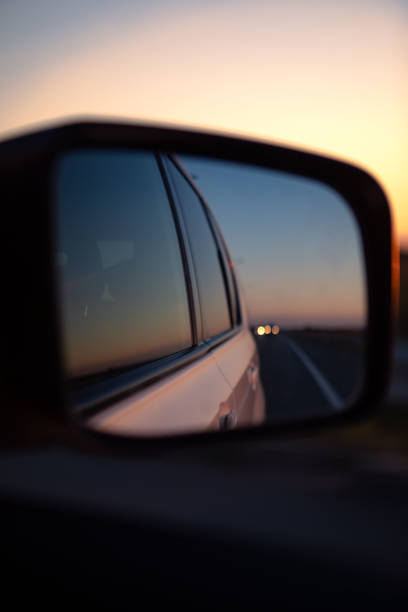 istock reflection in car rear mirror sunset on the road 1407988278