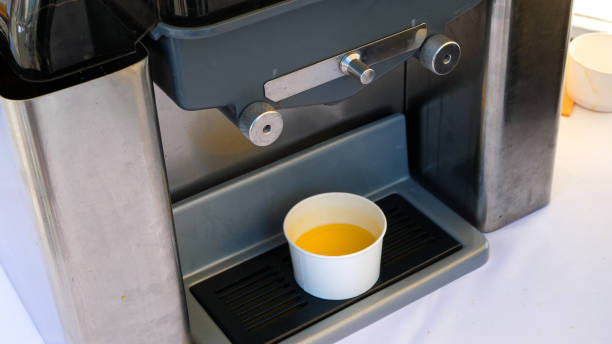 istock Juicer machine prepared for making fresh orange juice 1407988287