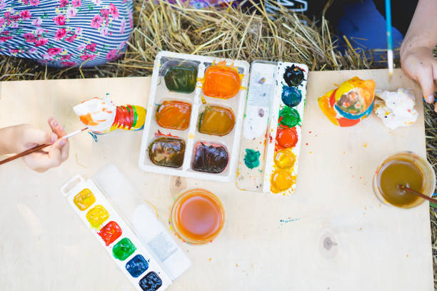 istock Children paint figurines with gypsum paints. 1407990774