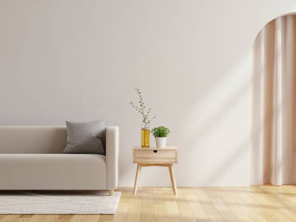 istock Wall mock up in warm tones with sofa on white wall background. 1407993587