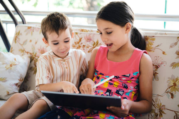 istock Happy Children Using Digital Tablet Outdoors 1407997734