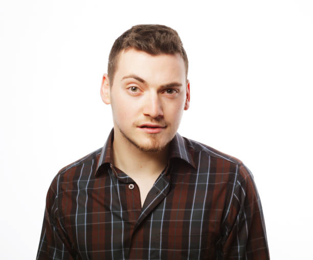 istock Handsome young man in shirt looking at camera 1407998936