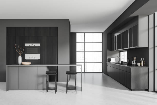 istock Grey kitchen interior with island and seats, appliances and panoramic window 1407998971