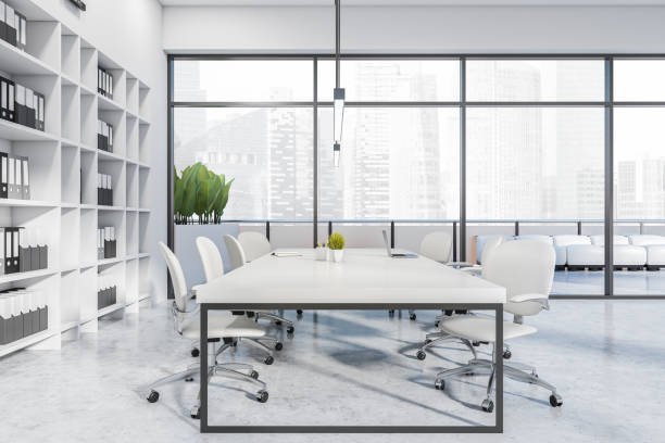 istock Light office room interior with chairs, table with laptop and panoramic window 1407999230