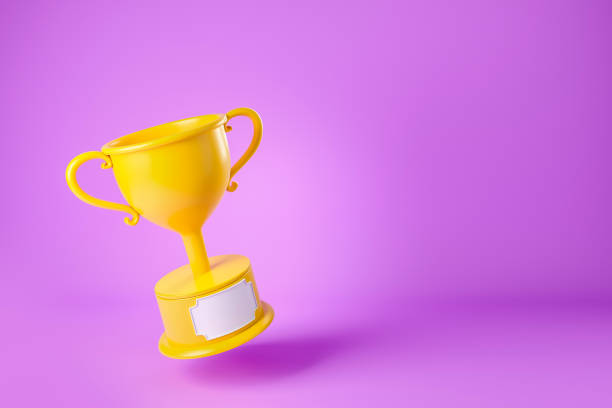 istock Gold cup on violet background, winner trophy. Copy space 1408000035