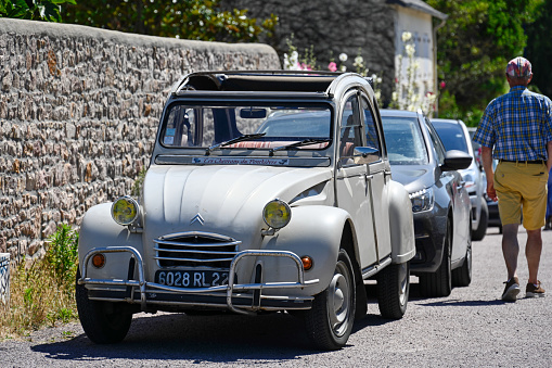 Erquy, France - July 9, 2022: An old timer classic Citroen 2CV (Dodoche ) in a very good shape. The Citroën 2CV (French deux chevaux \