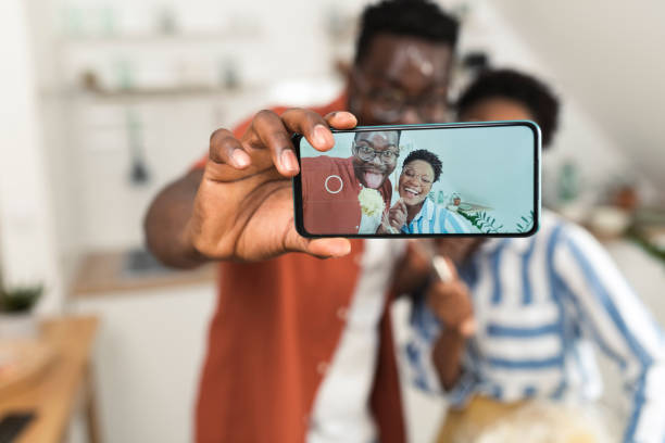 istock Afro couple taking a selfie while making cookies at home 1408002345