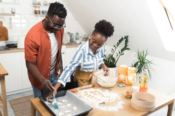 istock Afro husband and wife making cookies at their kitchen together 1408002365