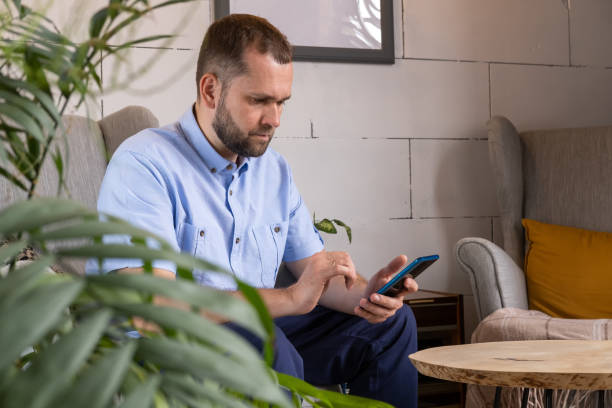 istock Smiling middle aged businessman freelancer using mobile phone checking social media feed or message chat 1408006194