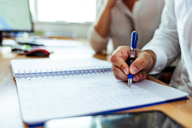 istock Man signing document, putting signature at paper. 1408007589