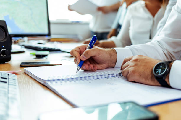 Close up of a man hand writing on notebook
