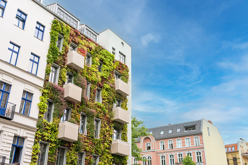 Apartment building with a plant covered facade. This sustainable building helps fight climate change and improves the quality of life of the residents.