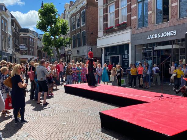 Haarlem, Netherlands, - June 28, 2022. People listening to a performance of a street singer in the city center.