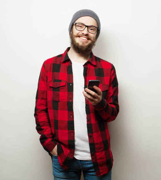 istock young bearded man with mobile phone 1408008205