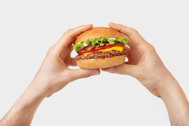 istock burger with cheese and beef in male hands on a white background 1408008281