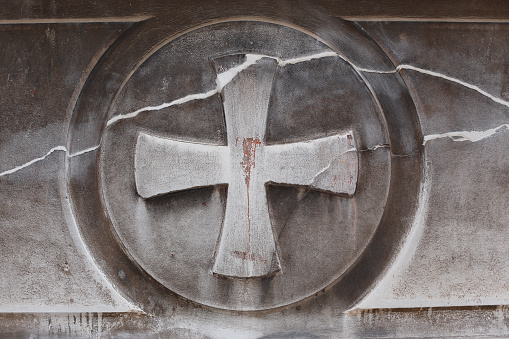 Cross symbol on a concrete texture