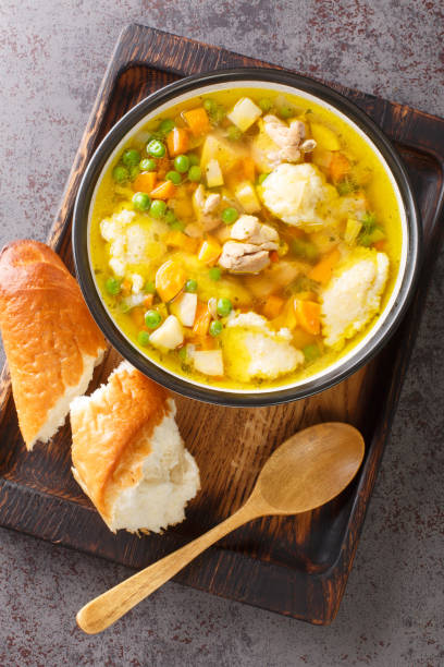 istock Eingemachtes Chicken Soup with Wheat Grits Dumplings close-up in a bowl. Vertical top view 1408009393