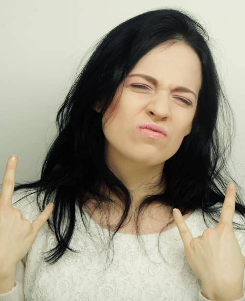 istock Funny woman doing hand sign 1408011035